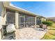 Spacious paver patio with screened enclosure, grill, and seating area at 14015 Kingfisher Glen Dr, Lithia, FL 33547