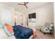 Bedroom with a queen bed, sitting chair, and built-in TV at 14015 Kingfisher Glen Dr, Lithia, FL 33547