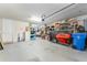 Garage with storage shelving and space for vehicles at 14015 Kingfisher Glen Dr, Lithia, FL 33547