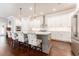 Modern kitchen with white cabinets, granite countertops, and breakfast bar at 14015 Kingfisher Glen Dr, Lithia, FL 33547