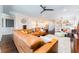 Spacious living room featuring a large leather sectional sofa and an open floor plan at 14015 Kingfisher Glen Dr, Lithia, FL 33547