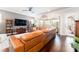 Spacious living room with a large sectional sofa and hardwood floors at 14015 Kingfisher Glen Dr, Lithia, FL 33547