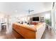 Open living room with hardwood floors and a large sectional sofa at 14015 Kingfisher Glen Dr, Lithia, FL 33547