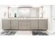 Main bathroom boasts double vanity with granite countertop and gray cabinets at 14015 Kingfisher Glen Dr, Lithia, FL 33547