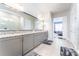 Main bathroom with double vanity and large mirror reflecting the shower at 14015 Kingfisher Glen Dr, Lithia, FL 33547