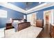 Main bedroom with barn door to en-suite bath and ceiling fan at 14015 Kingfisher Glen Dr, Lithia, FL 33547