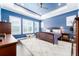 Blue-walled main bedroom with a king-size bed and a ceiling fan at 14015 Kingfisher Glen Dr, Lithia, FL 33547