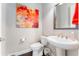 Elegant powder room with a pedestal sink and a modern floral art piece at 14015 Kingfisher Glen Dr, Lithia, FL 33547