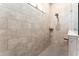 Large walk-in shower with neutral-toned tile and built-in shelf at 14015 Kingfisher Glen Dr, Lithia, FL 33547