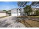 Two-story house with gray exterior, white garage door, and driveway at 1703 Alhambra Crest Dr, Ruskin, FL 33570