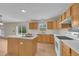 Kitchen features island, wood cabinets, and white appliances at 1703 Alhambra Crest Dr, Ruskin, FL 33570