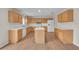 Kitchen with island, wood cabinets, and white appliances at 1703 Alhambra Crest Dr, Ruskin, FL 33570