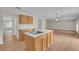 Bright kitchen with island, wood cabinets, and white appliances at 1703 Alhambra Crest Dr, Ruskin, FL 33570