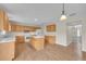 Open kitchen with island, wood cabinets, and white appliances at 1703 Alhambra Crest Dr, Ruskin, FL 33570
