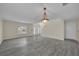 Spacious living room with gray vinyl flooring and chandelier at 1703 Alhambra Crest Dr, Ruskin, FL 33570