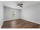 Spacious bedroom featuring wood-look floors and a ceiling fan at 17447 Spring Valley, Dade City, FL 33523