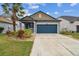 Two-story house with a blue garage door and landscaping at 21093 Wistful Yearn Dr, Land O Lakes, FL 34637