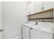 Laundry room with washer, dryer, and shelving at 21093 Wistful Yearn Dr, Land O Lakes, FL 34637