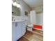 Bright bathroom featuring white cabinets, modern fixtures, and a shower-tub combination, complete with wood-look floors at 2284 Philippine Dr # 71, Clearwater, FL 33763