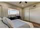 Cozy bedroom featuring wood floors, a computer desk, and bright natural light from the exterior window at 2284 Philippine Dr # 71, Clearwater, FL 33763