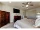 Comfortable bedroom with a ceiling fan, two dressers, and a mounted television at 2284 Philippine Dr # 71, Clearwater, FL 33763