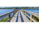 Picturesque view of a wooden dock extending into a serene lake, perfect for fishing or peaceful relaxation at 2284 Philippine Dr # 71, Clearwater, FL 33763