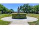 Lush outdoor garden with a statue atop a hedge, with an archway feature adding to the serene setting at 2284 Philippine Dr # 71, Clearwater, FL 33763