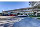 A condominium building showcases a well-maintained exterior with ample parking and manicured landscaping at 2284 Philippine Dr # 71, Clearwater, FL 33763
