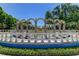 Picturesque garden vista featuring an archway in a sunny outdoor area surrounded by lush landscaping at 2284 Philippine Dr # 71, Clearwater, FL 33763