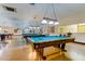 Inviting game room with several pool tables under decorative lighting, ready for friendly competition and entertainment at 2284 Philippine Dr # 71, Clearwater, FL 33763