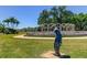 A serene garden setting with a distant archway feature and decorative statue, offering a peaceful view at 2284 Philippine Dr # 71, Clearwater, FL 33763