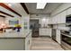 Well-lit kitchen features granite countertops, stainless steel appliances, and wood-look floors for a modern feel at 2284 Philippine Dr # 71, Clearwater, FL 33763