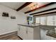 Stylish kitchen island with granite countertop, white cabinetry, and seating for two at 2284 Philippine Dr # 71, Clearwater, FL 33763
