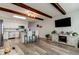 Open floor plan with a modern kitchen adjacent to a living area with stylish wood-look floors and beamed ceilings at 2284 Philippine Dr # 71, Clearwater, FL 33763