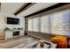 Bright living room features wood-look floors, beamed ceilings, a large window, and modern decor at 2284 Philippine Dr # 71, Clearwater, FL 33763
