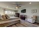 Comfortable main bedroom with warm lighting, modern furniture, wood flooring, and a large window at 2284 Philippine Dr # 71, Clearwater, FL 33763