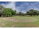 Manicured putting green featuring lush grass and mature trees at 2284 Philippine Dr # 71, Clearwater, FL 33763