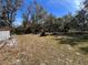 Backyard with various equipment and debris at 26418 Dayflower Blvd, Wesley Chapel, FL 33544