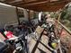 Cluttered porch with various items and debris at 26418 Dayflower Blvd, Wesley Chapel, FL 33544