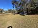 Side yard with vehicles parked on the grass at 26418 Dayflower Blvd, Wesley Chapel, FL 33544