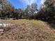A mostly empty side yard with some debris at 26418 Dayflower Blvd, Wesley Chapel, FL 33544