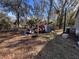 Side yard with various debris and scattered items at 26418 Dayflower Blvd, Wesley Chapel, FL 33544
