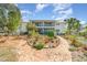 Brick pathway leads to a charming two-story home with lush gardens at 2700 Magdalina Dr # 2B, Punta Gorda, FL 33950
