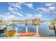 Serene canal view with a docked boat and orange kayak at 2700 Magdalina Dr # 2B, Punta Gorda, FL 33950