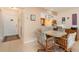 Small dining area with table and chairs, open to kitchen at 2700 Magdalina Dr # 2B, Punta Gorda, FL 33950