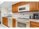Well-equipped kitchen with modern appliances and wood cabinets at 2700 Magdalina Dr # 2B, Punta Gorda, FL 33950