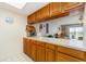 Kitchen features wood cabinets and pass-through to living area at 2700 Magdalina Dr # 2B, Punta Gorda, FL 33950