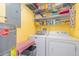 Laundry room with washer, dryer, and shelving at 2700 Magdalina Dr # 2B, Punta Gorda, FL 33950