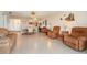 Living area with open concept and brown leather furniture at 2700 Magdalina Dr # 2B, Punta Gorda, FL 33950