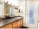 Bathroom with double vanity and access to backyard at 3011 Marble Crest Dr, Land O Lakes, FL 34638